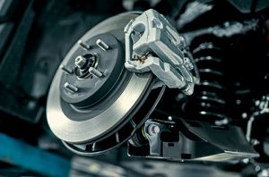 DiscBrakeOfTheVehicleForRepairInProcessOf - Meineke Car Care - Texas Meineke Car Care | Brake Calipers | Lewisville