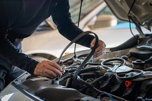 ProfessionalMechanicManHoldingTimingBeltOfACarFor - Meineke Car Care - Texas Meineke Car Care | AC Belt | Farmers Branch TX